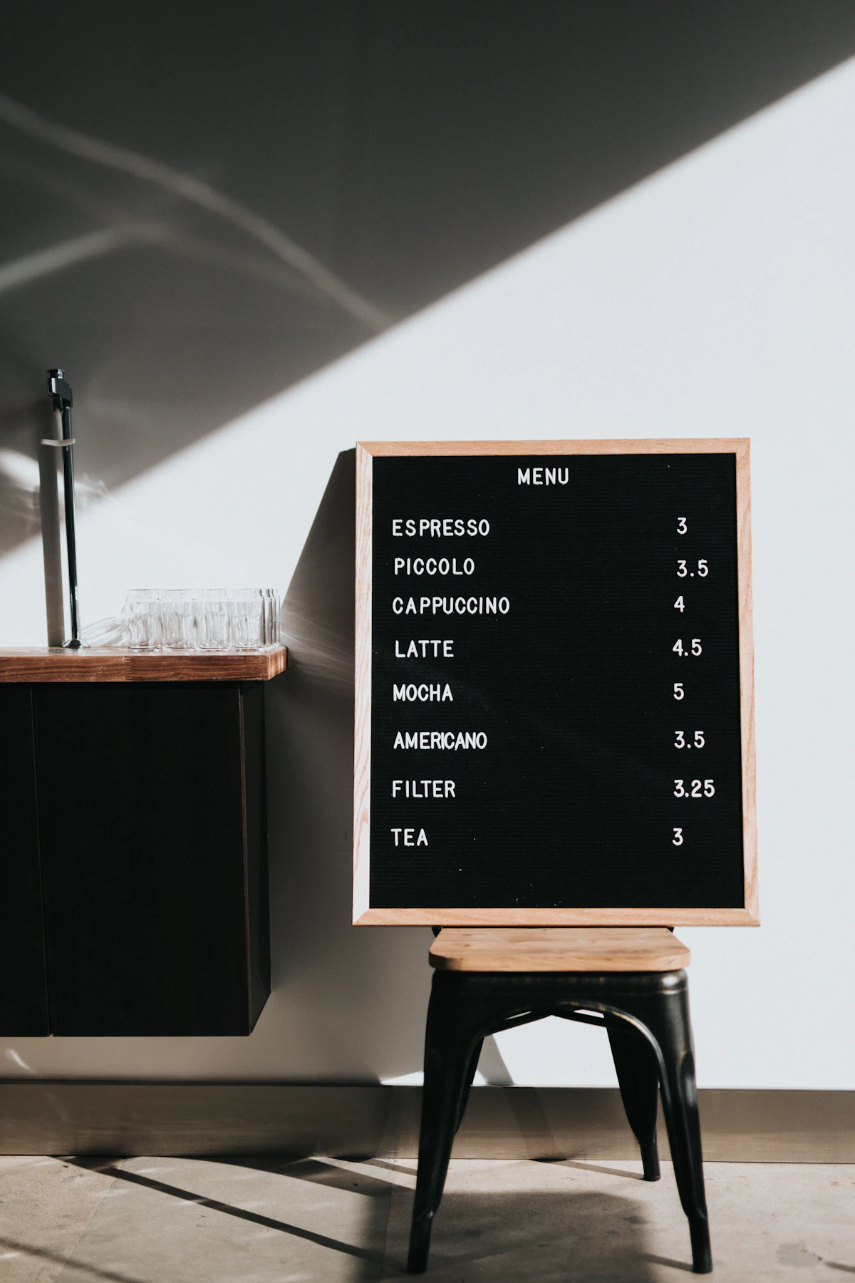 A cafe’s menu and wooden counter in natural light